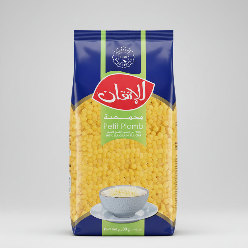 Box of Petit Plombs pasta with a bowl of pasta on a white background