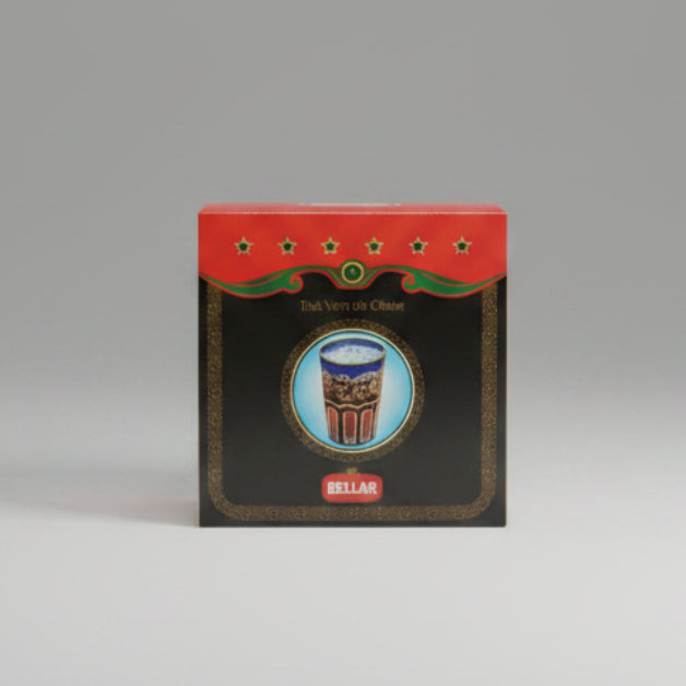 A square black retail box for Bellar Thé Vert de Chine, wrapped in clear plastic, featuring a red top band with green stars and a central illustration of a blue-and-red tea cup.