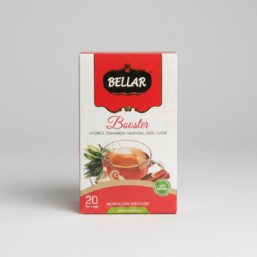 A box of Bellar Booster Moroccan Infusion tea bags, featuring a red and white package with illustrations of tea and spices, set on a countertop with a blurred kitchen background.