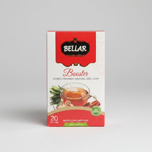 A box of Bellar Booster Moroccan Infusion tea bags, featuring a red and white package with illustrations of tea and spices, set on a countertop with a blurred kitchen background.